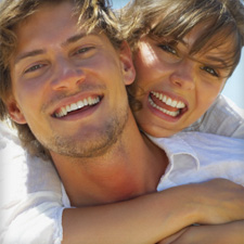 Smiling couple with dental implants